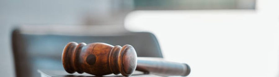 Justice, Gavel And Law Books On Table In Office For Court Trial, Legislation Or Fair Constitution By Judicial System. Firm, Closeup And Legal Hammer By Information For Corporate Case In Workplace.